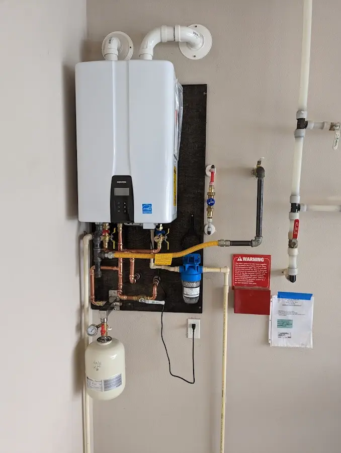 Professional plumber installing copper piping in a Rapho home